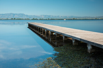 Obraz premium Seascape with wooden breakwater. Morning of blue sky and sea. Peace, tranquility, solitude, calm, relaxation, yoga, zen, spirituality