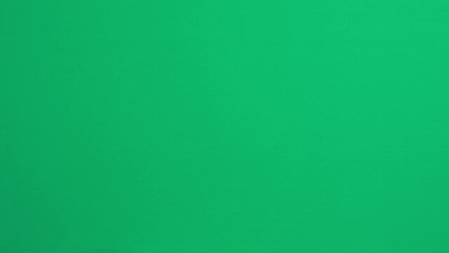 Hand gestures. Teenage boy hand touching, clicking, tapping, sliding, dragging and swiping on green screen chroma key background. Using a smartphone, digital tablet, computer touchscreen