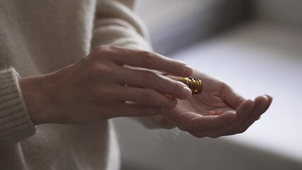 Woman feels bad, takes pills of anesthetic medicine, aspirin, analgin, painkillers pouring pills with medicines in hand. Take pills for headache. Patient is treated independently at home
