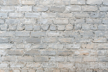 White grunge brick wall background. Urban background, white ruined industrial brick wall with copy space