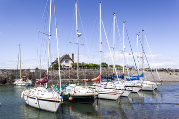 Obraz premium Yachts moored in the harbour on the edge of Exmoor at Porlock Weir, Somerset UK