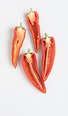 Split Red Peppers with Seeds and Pulp on White Background