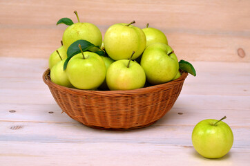 green apples in the basket and on the table