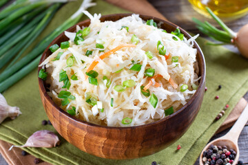 Sauerkraut salad in a wooden plate. Healthy food