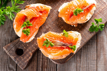 Slices of fresh baguette with butter and salmon