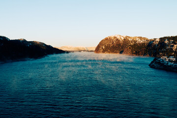 Fototapeta na wymiar Frost smoke on a winter fjord of Middle Norway.