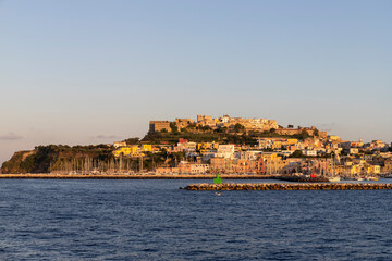 Fototapeta na wymiar Procida island at sunset seen from the sea, Gulf of Naples, Italy