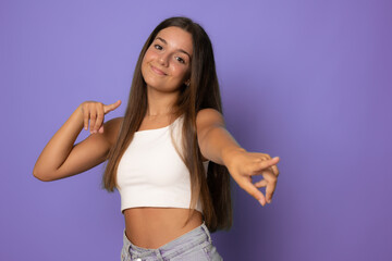 Young woman wearing casual summer clothes pointing to you and the camera with fingers, smiling positive and cheerful