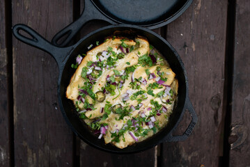 Simple & Delicious Mexican Food, Enchiladas in Cast Iron Dutch Oven Cooked Over the Campfire Outside 