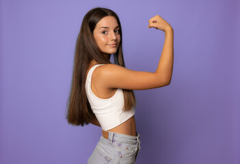 Young woman over isolated background doing strong gesture