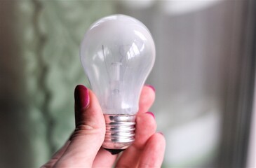 isolated light bulb in hand light