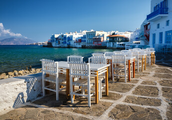 A restaurant overlooking Little Venice, Mykonos Island, Greece. Lunch and dinner overlooking the sea. Photo as wallpaper.