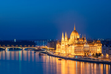 Fototapeta na wymiar Side view of the Hungarian Parliament building illuminated in Budapest, during blue hour