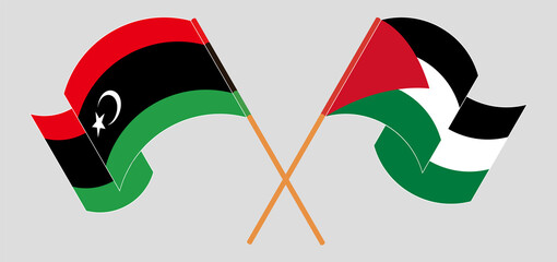Crossed and waving flags of Libya and Palestine