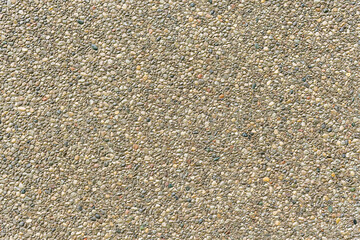 Background wall with an even stucco surface of small pebbles. Banner space.