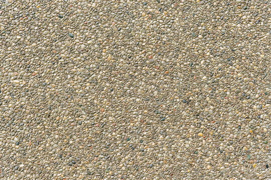 Background wall with an even stucco surface of small pebbles. Banner space.