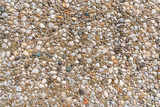 Background wall with an even stucco surface of small pebbles. Banner space.