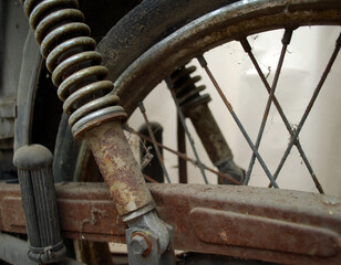 Historical, old but still working shock absorber with view on part of wheel.