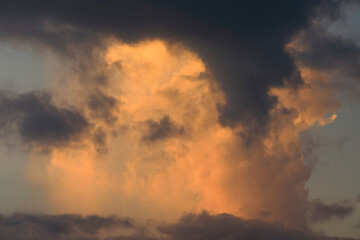 Beautiful clouds with orange and golden light, dramatic sky by by the sunrise.