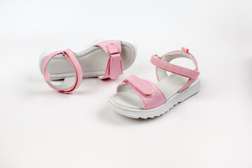 Pink insulated sandals. Children's pink sandals with white soles and Velcro fasteners isolated on a white background. Fashionable children's shoes for children. 