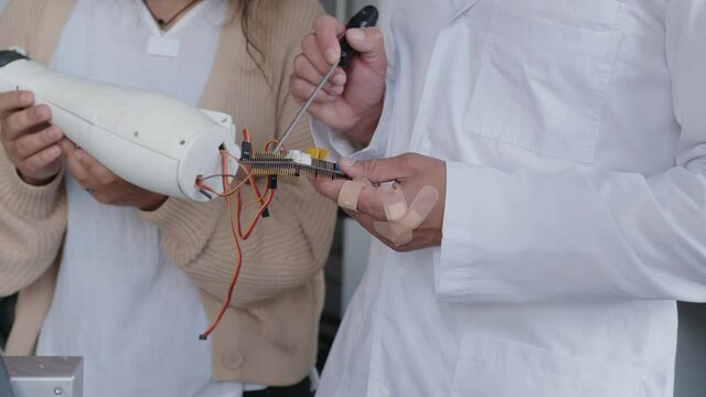 Close up girls and techer's hands with 3D printed hand