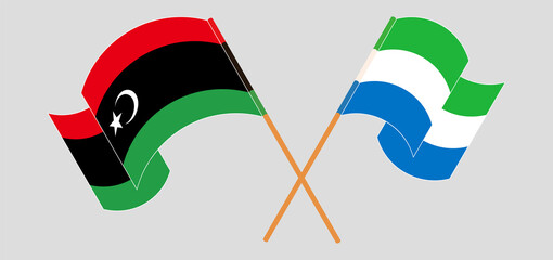 Crossed and waving flags of Libya and Sierra Leone