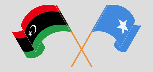Crossed and waving flags of Libya and Somalia