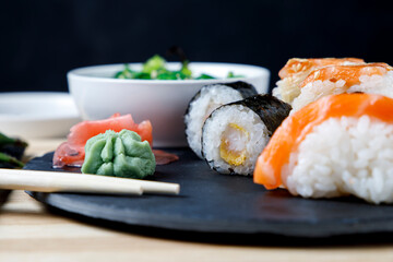 Assortment of sushi, niguiri and rolls with wasabi