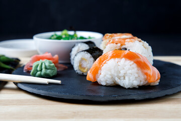 Assortment of sushi, niguiri and rolls with wasabi