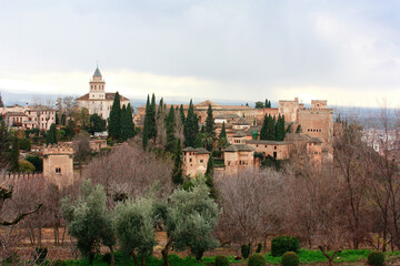 Granada, Spain. View of the Alhambra Palace in Granada, Spain with Sierra Nevada mountains as backdrop during sunny day
