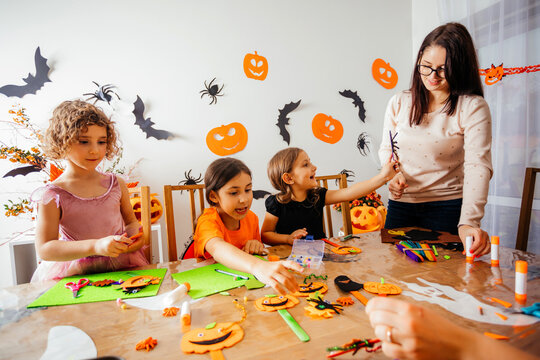 Happy children during Halloween art lesson at home