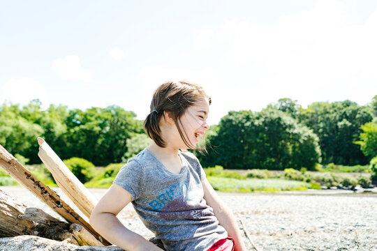 Side view of a young child laughing at the beach