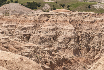 Badlands National Park, SD, USA - June 1, 2008: Closeup of canyon wall of beige-brown geological...