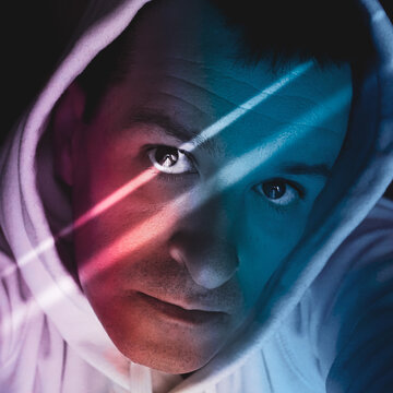 man portrait with blue and red light in the shadows