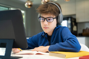 Young collage student using computer and mobile device studying