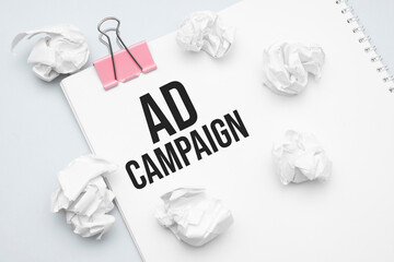 ad campaign. Blank sheet of paper, red paper clip, word Ideas and crumpled paper wads