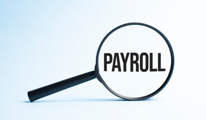 Magnifying glass with the word Payroll. Business concept