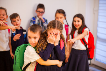 The brave little schoolboy protects a schoolgirl while bullying