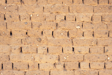 Closeup of building wall of adobe mud sun dried bricks showing texture during construction in Turkey.