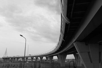 view on bridge over the river in the city from under in black and white