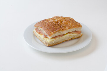 Homemade focaccia stuffed with ham and cheese isolated on white background