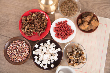 Different dishes filled with different medicinal herbs on the table