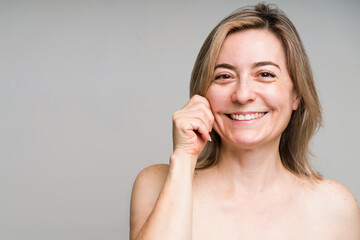 Fototapeta premium Portrait of a beautiful old woman touching her face