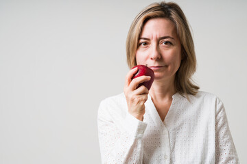 Attractive older woman holding fresh fruit