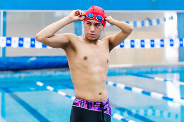 Paralympic disabled Swimmer latin man Training In Pool with hand hypoplasia in disability concept...