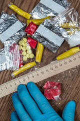 evidence of smuggling traffic: packages of unknown drugs next to the forensic scale
