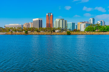 Fototapeta premium The Long Beach skyline stands above the calm water of a bay of the Pacific Ocean.