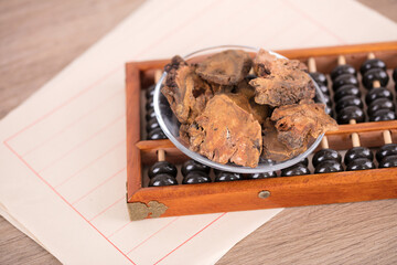 A plate of Chinese medicine rhubarb and abacus beads on the table