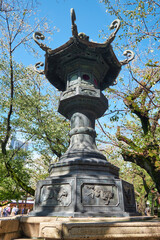 Fototapeta premium The bronze lantern in the garden of Yasukuni Shrine in Chiyoda, Tokyo. Japan
