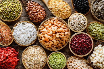 Variety kind of dry organic cereal and grain seeds in wooden bowl in dark tone, for healthy or clean food ingredient or agricultural product concept